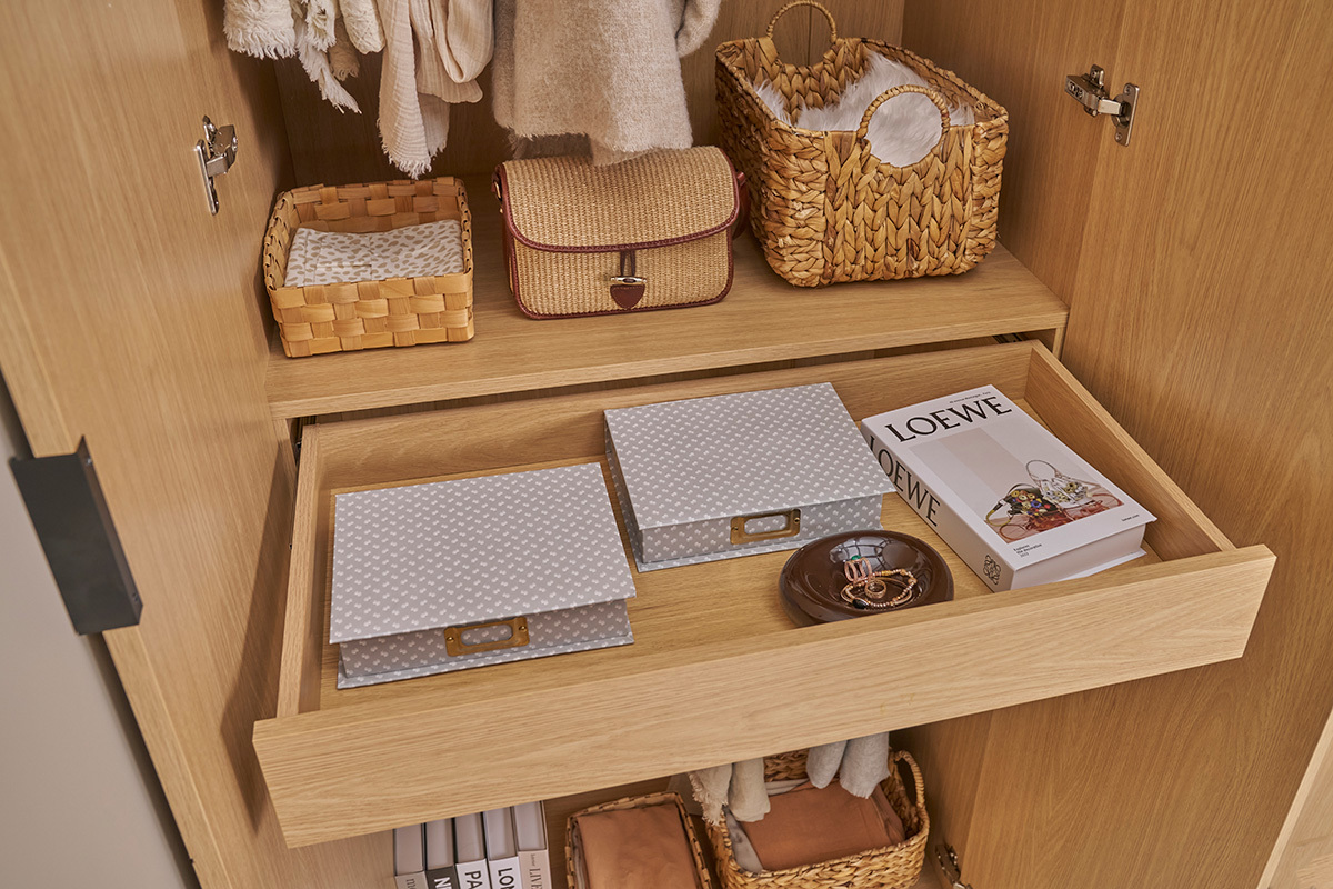 Int�rieur d'une armoire en ch�ne avec tiroir ouvert, rangements et paniers.