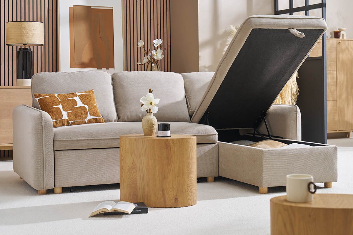 Canap� d'angle convertible beige avec coffre ouvert, table en bois devant.