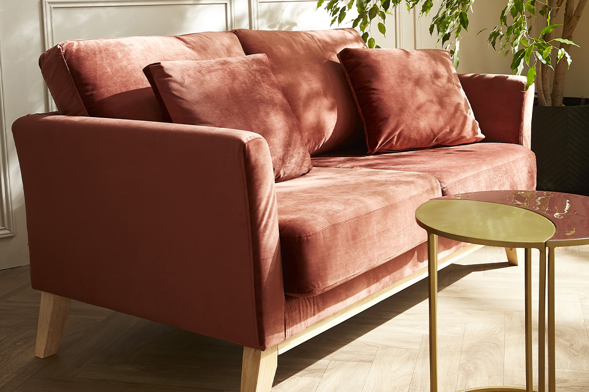 Canap� scandinave 2 places en velours rouge avec pieds en bois clair, vue d'angle.