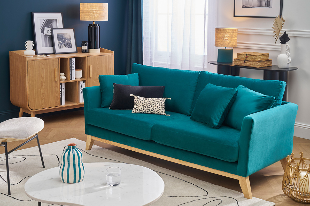 Canap� scandinave bleu p�trole avec pieds bois, vue de face, dans un salon moderne.